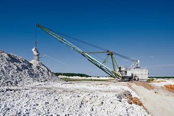 Old dragline mines minerals in chalk quarry on sunny day