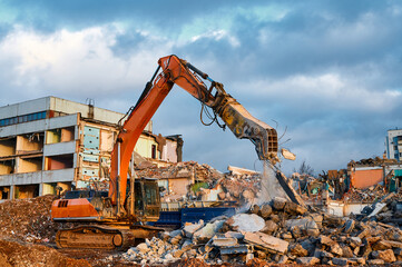 Fototapeta premium Excavator with concrete crusher on rig at demolition site