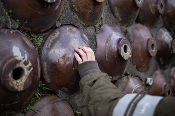 古い焼き物が埋め込まれた美しい壁に触れる