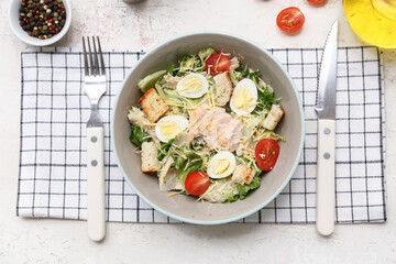 Bowl with tasty chicken Caesar salad and peppercorn on white background