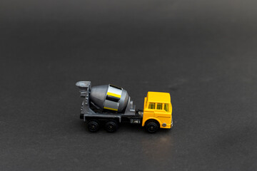 Toy cement mixer truck on black background