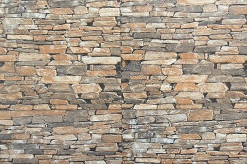Obraz premium Brown and gray artificial stone garden fence details, stone tile wall texture image.