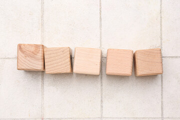 Wooden cubes on light tile background. Rules concept