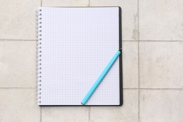 Blank notebook on light tile background. Rules concept