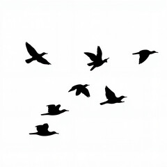 Fototapeta premium Flock of birds flying across a bright sky during the day