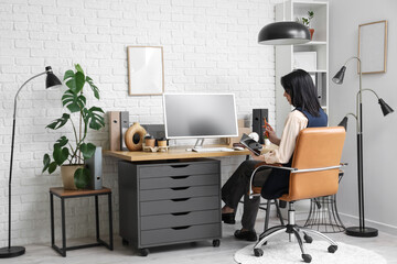 Young woman working with computer in modern office