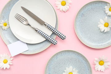 Stylish table setting with beautiful chrysanthemum flowers on pink background