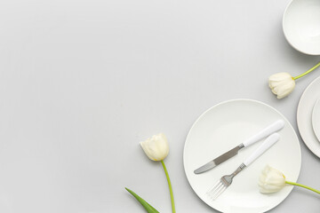 Stylish table setting with beautiful tulip flowers on grey background