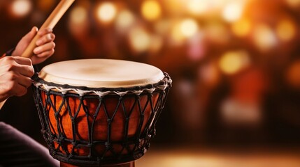 A close-up of hands playing a traditional Brazilian drum with a mallet, set against a blurred warm background, highlighting the rhythm and festive atmosphere
