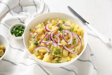 Bowl of tasty potato salad with onion and dill on white background