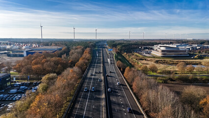 Fototapeta premium Industrial landscape with highway and cars traffic aerial drone view from above, modern motorway road in industrial zone, Netherlands