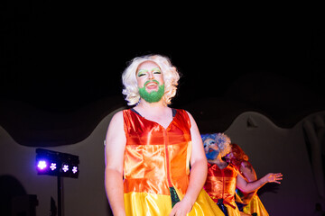 Fototapeta premium Drag queen with colorful makeup performing on stage