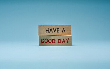 Have a good day is written on wooden blocks standing on a blue background