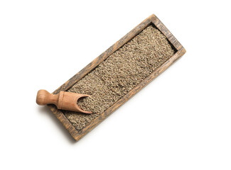 Wooden tray and scoop with dried anise seeds on white background