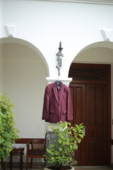 wedding gowns hanging in the garden in preparation for the wedding event