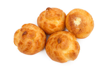 Profiteroles with buttercream on a white background. Fresh sweet cakes.