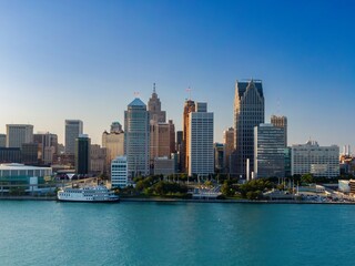 Obraz premium Detroit skyline, viewed from the river, with a riverboat. City's architectural beauty. DETROIT RIVER, DETROIT, MICHIGAN, UNITED STATES
