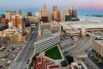 High-angle view of Detroit's urban landscape. City streets, buildings, and parking garages are visible. Traffic flows through the city. DOWNTOWN, DETROIT, MICHIGAN, UNITED STATES
