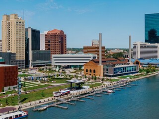 Aerial view of downtown, showing ProMedica headquarters, a waterfront park, and marina. Urban...