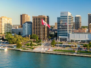 Aerial view of downtown city park, with the Canadian flag, and people relaxing. Cityscape with...
