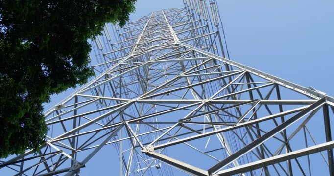 View from below of an electric transmission tower made of tubular steel.
