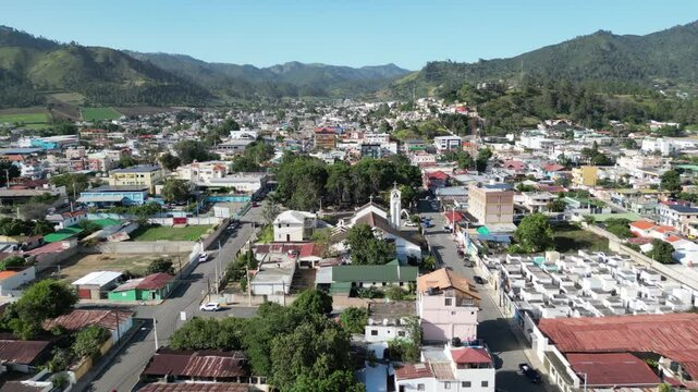 Aerial view of the town center and the central park of Constanza in the Central Range of the Dominican Republic on a sunny summer day