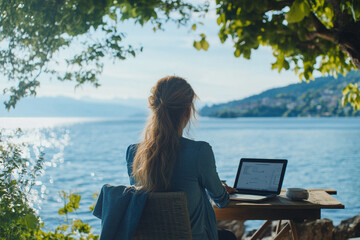 Woman enjoying a remote work setup with peaceful lake views.