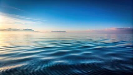 A serene ocean scene with gentle ripples on the surface of the water, surrounded by a misty morning atmosphere and distant rocky shores , water, shoreline