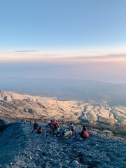 Fototapeta premium Hikers Ascending Mount Rinjani at Sunrise, Indonesia