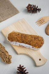 a toast with beef floss topping on a white table photographed with studio lighting and wooden theme props