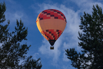 A hot air balloon flies in the sky at a height
