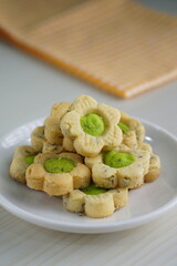 Indonesian mint cookies photographed on a white table with a wooden theme in an indoor studio