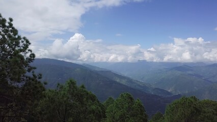 A breathtaking mountain landscape adorned with lush green trees captures the beauty of nature....