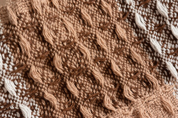 Brown plaid texture. Presentation of the fashionable color of 2025 mocha mousse. Warm, cozy shades of chocolate, beige, brown. The texture of a woolen plaid in close-up. The concept of home comfort