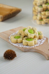 Indonesian mint cookies photographed on a white table with a wooden theme in an indoor studio