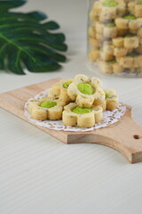 Indonesian mint cookies photographed on a white table with a wooden theme in an indoor studio