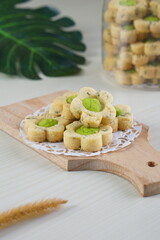 Indonesian mint cookies photographed on a white table with a wooden theme in an indoor studio