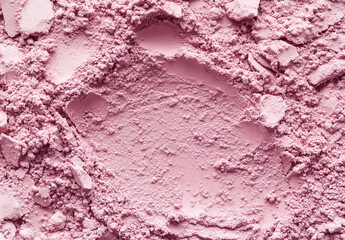 Pink clay cosmetic texture on the background, close-up. Background of smudged cream for face or body mask. Close-up of a pink creamy swatch.