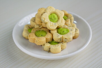 Indonesian mint cookies photographed on a white table with a wooden theme in an indoor studio