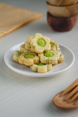 Indonesian mint cookies photographed on a white table with a wooden theme in an indoor studio