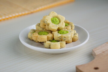 Indonesian mint cookies photographed on a white table with a wooden theme in an indoor studio