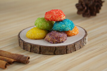Indonesian colorful granulated sugar sprinkled biscuits photographed with a wooden theme in an indoor studio