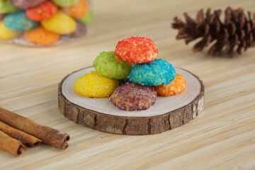 Indonesian colorful granulated sugar sprinkled biscuits photographed with a wooden theme in an indoor studio