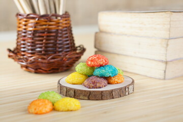 Indonesian colorful granulated sugar sprinkled biscuits photographed with a wooden theme in an indoor studio