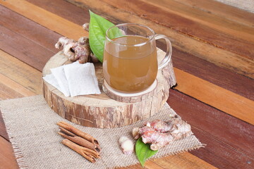 red ginger brewed drink photographed in a studio setting with traditional Indonesian theme props