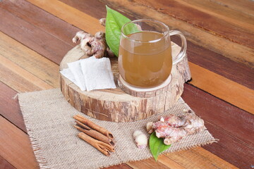 red ginger brewed drink photographed in a studio setting with traditional Indonesian theme props
