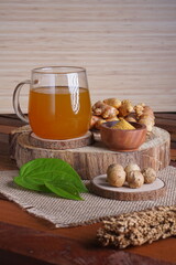 herbal drink made from turmeric, betel leaves and oak galls photographed in a studio setting with traditional Indonesian theme props