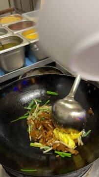 wok cooking, making Thai stir fried noodles (pad see ew)