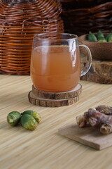 red ginger and areca nut brewed drink photographed in a studio setting with traditional Indonesian theme props