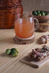 red ginger and areca nut brewed drink photographed in a studio setting with traditional Indonesian theme props